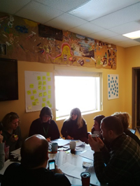 Photo of Staff of Centre de santé communautaire CHIGAMIK Community Health Centre working through QI exercises from the Introduction to IDEAS program